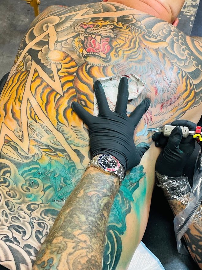 Jason Hobbie tattooing a large traditional Japanese backpiece at Classic Tattoo