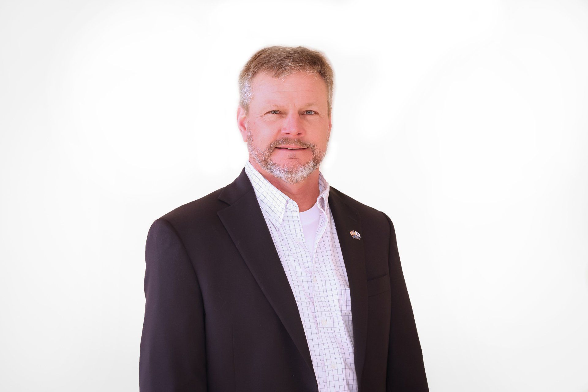 a man in a suit and white shirt is standing in front of a white background
