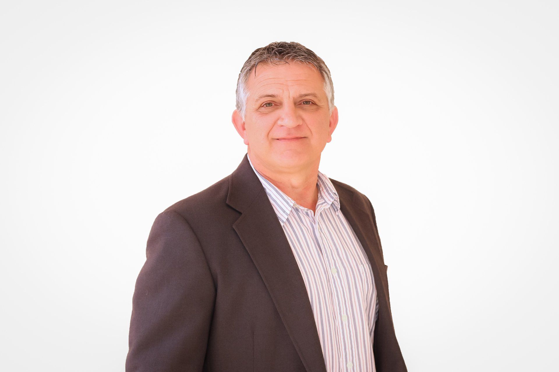 a man in a suit and striped shirt is standing in front of a white background