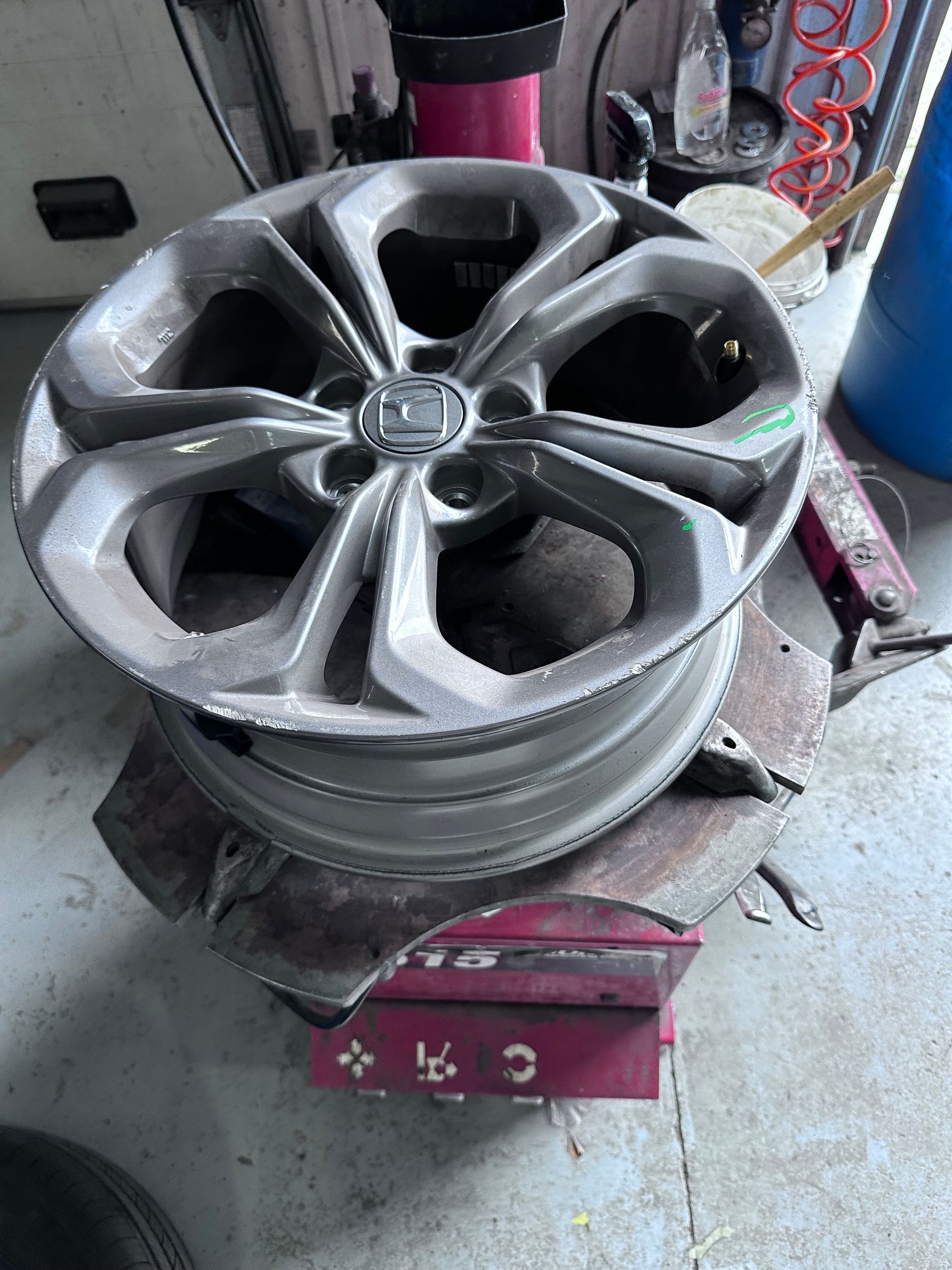 Alloy car wheel rim on a tire-changing machine in a workshop