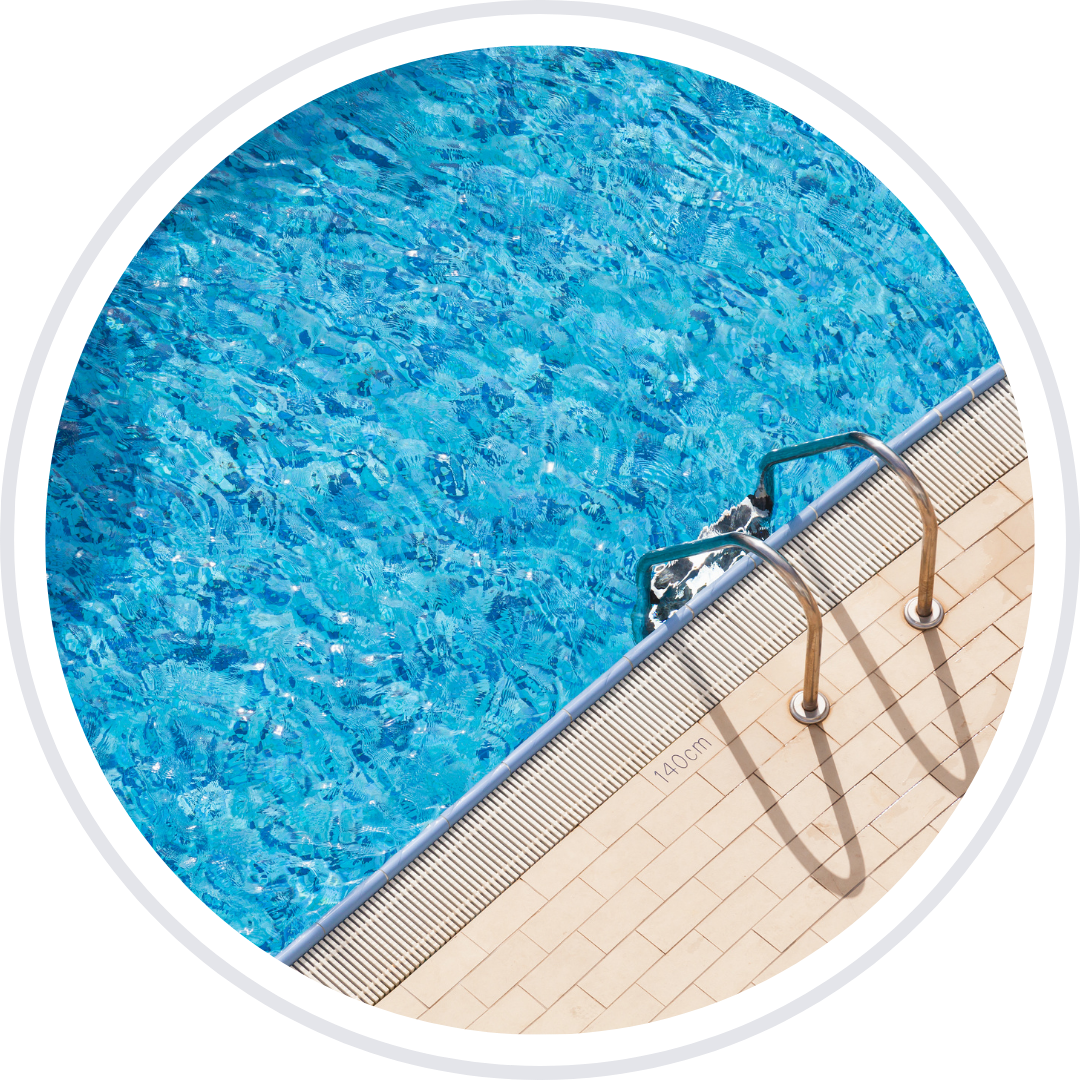 A blue swimming pool with a metal ladder at the edge.