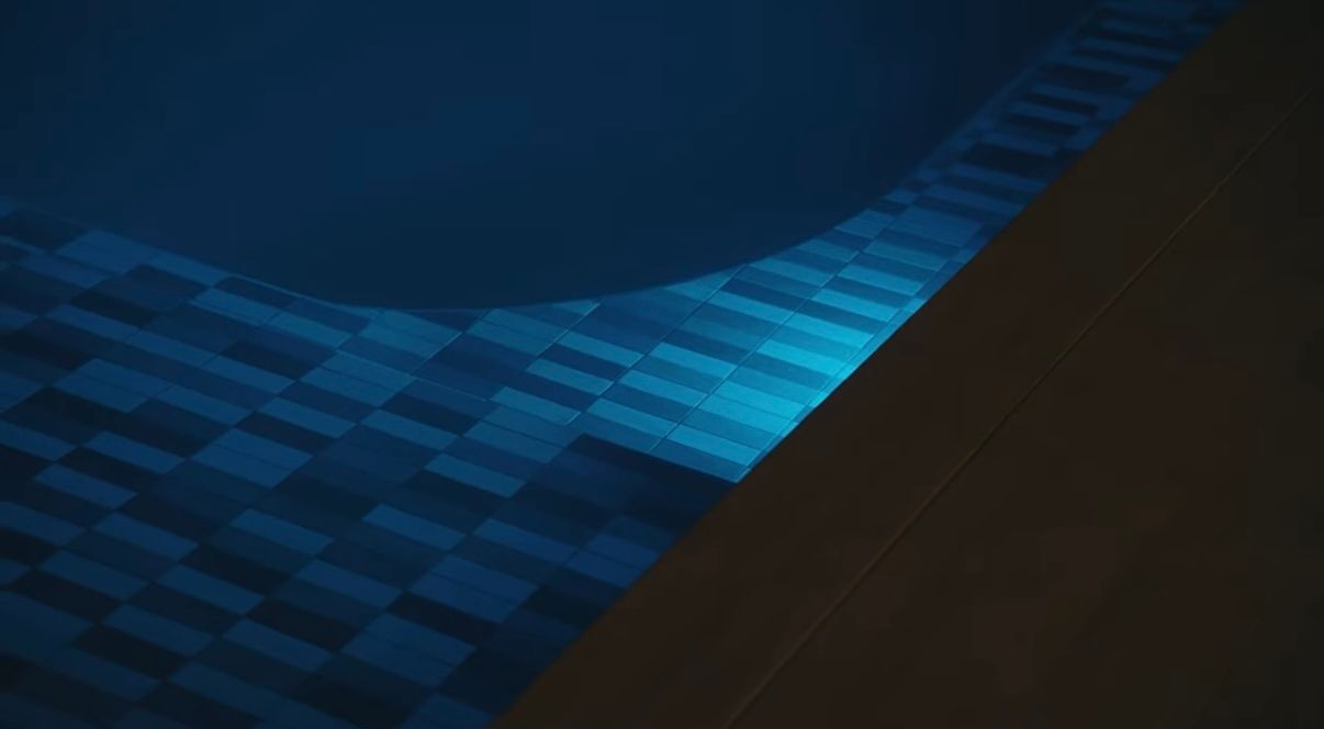 Abstract blue checkered pattern with a dark diagonal section across the frame