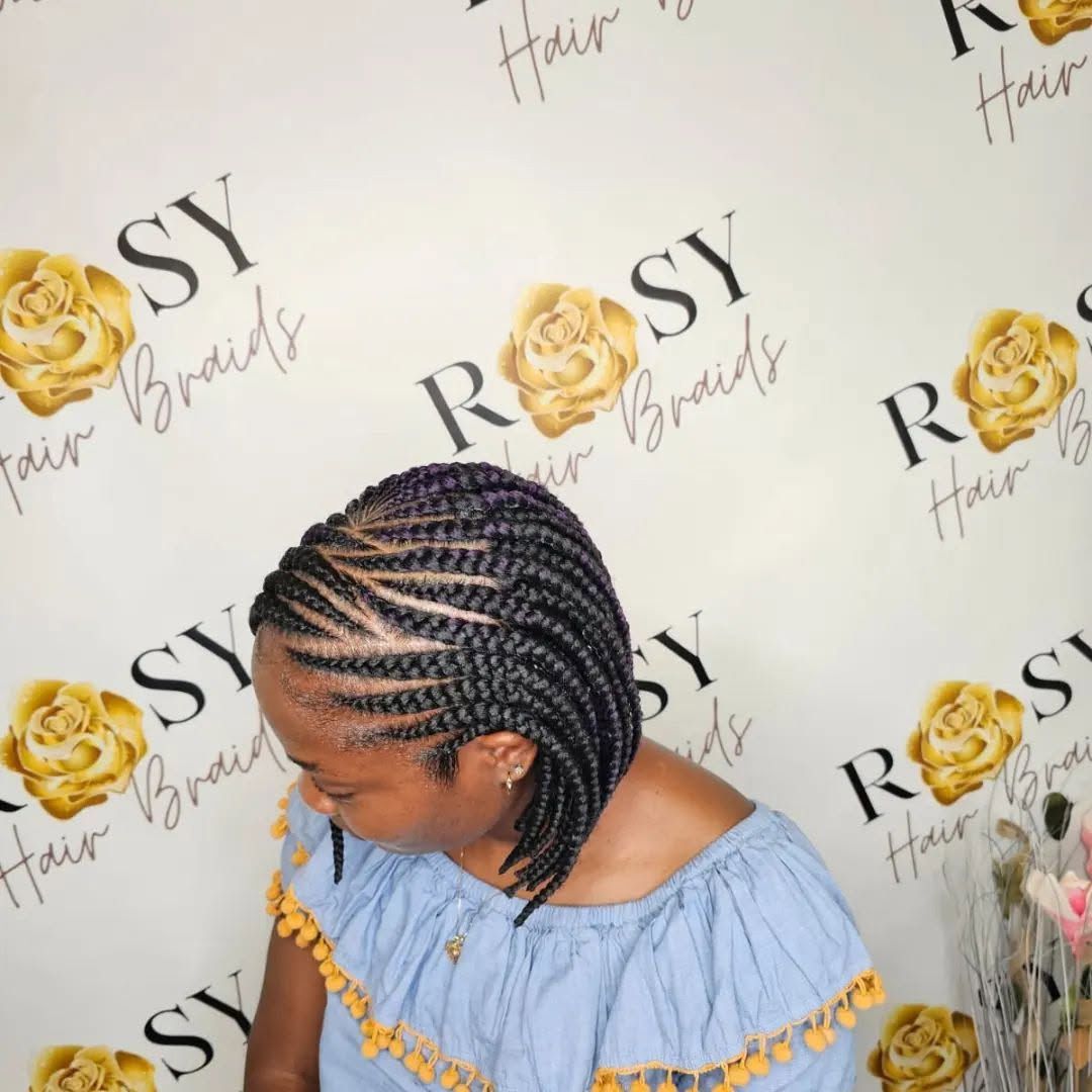 A woman with braids in front of a wall that says rosy hair braids