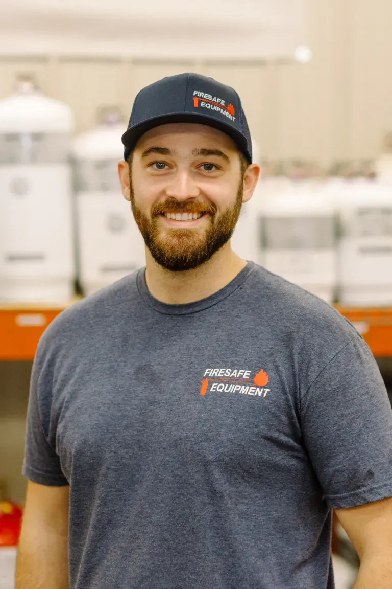 A man with a beard is wearing a hat and a t-shirt.