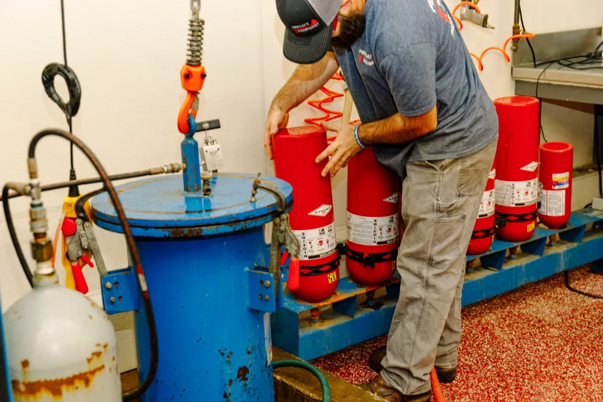 A man is working on a machine in a room.