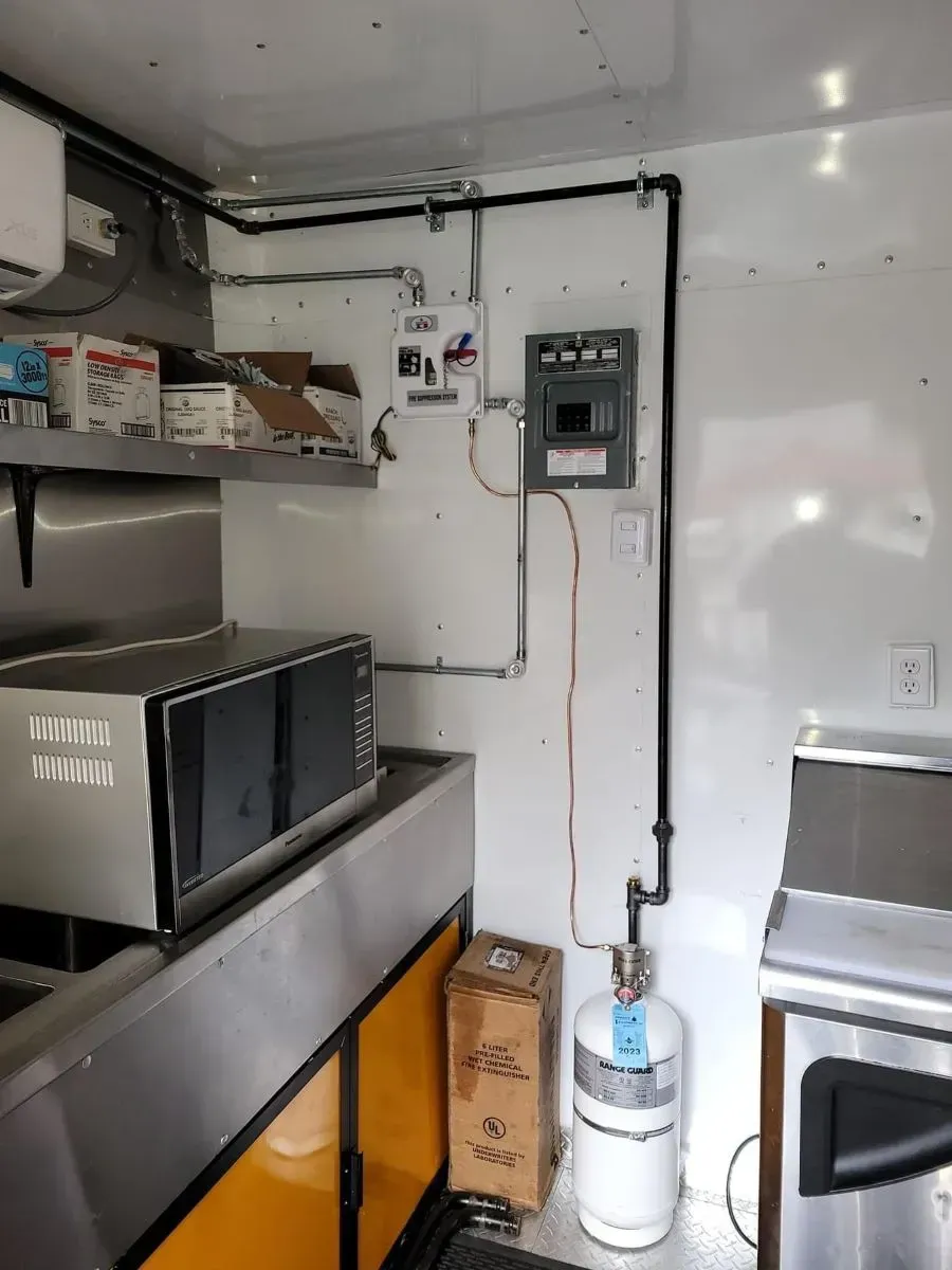 A kitchen with stainless steel appliances and a microwave