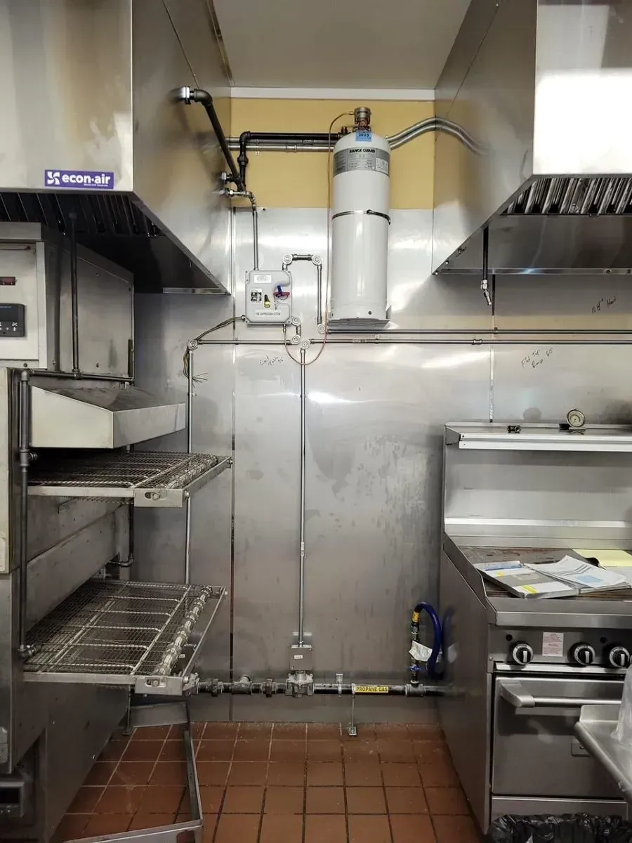 A kitchen with stainless steel appliances and a water heater