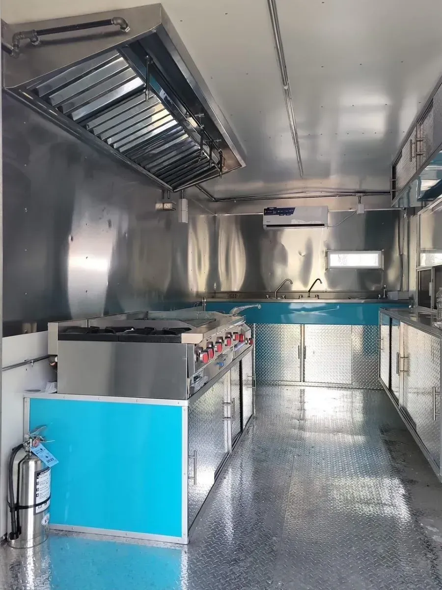 A kitchen with stainless steel appliances and a blue counter.
