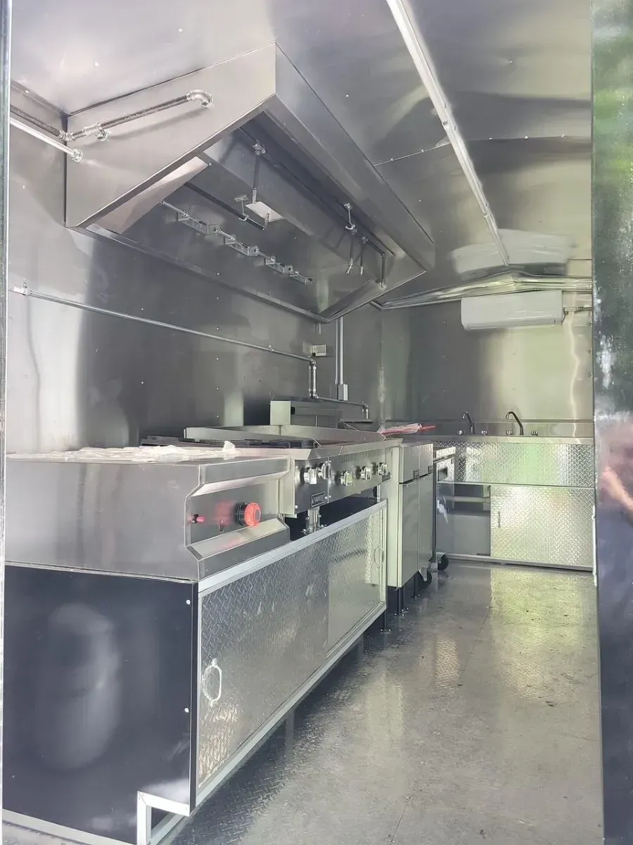 A kitchen with a lot of stainless steel appliances and a stove.