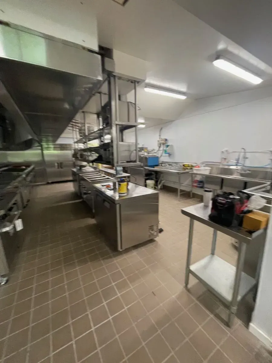 A kitchen with a lot of stainless steel appliances and a sink.