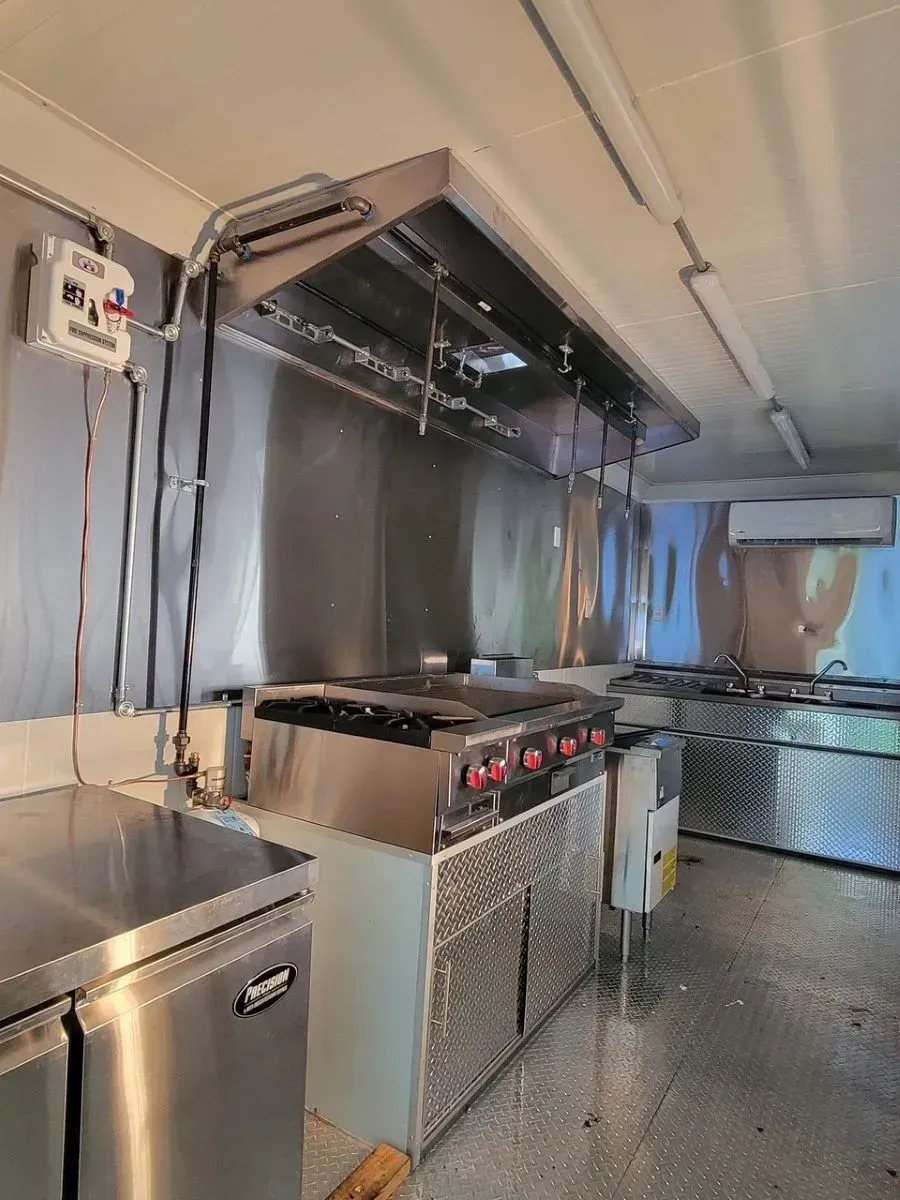 A kitchen with stainless steel appliances and a stove.