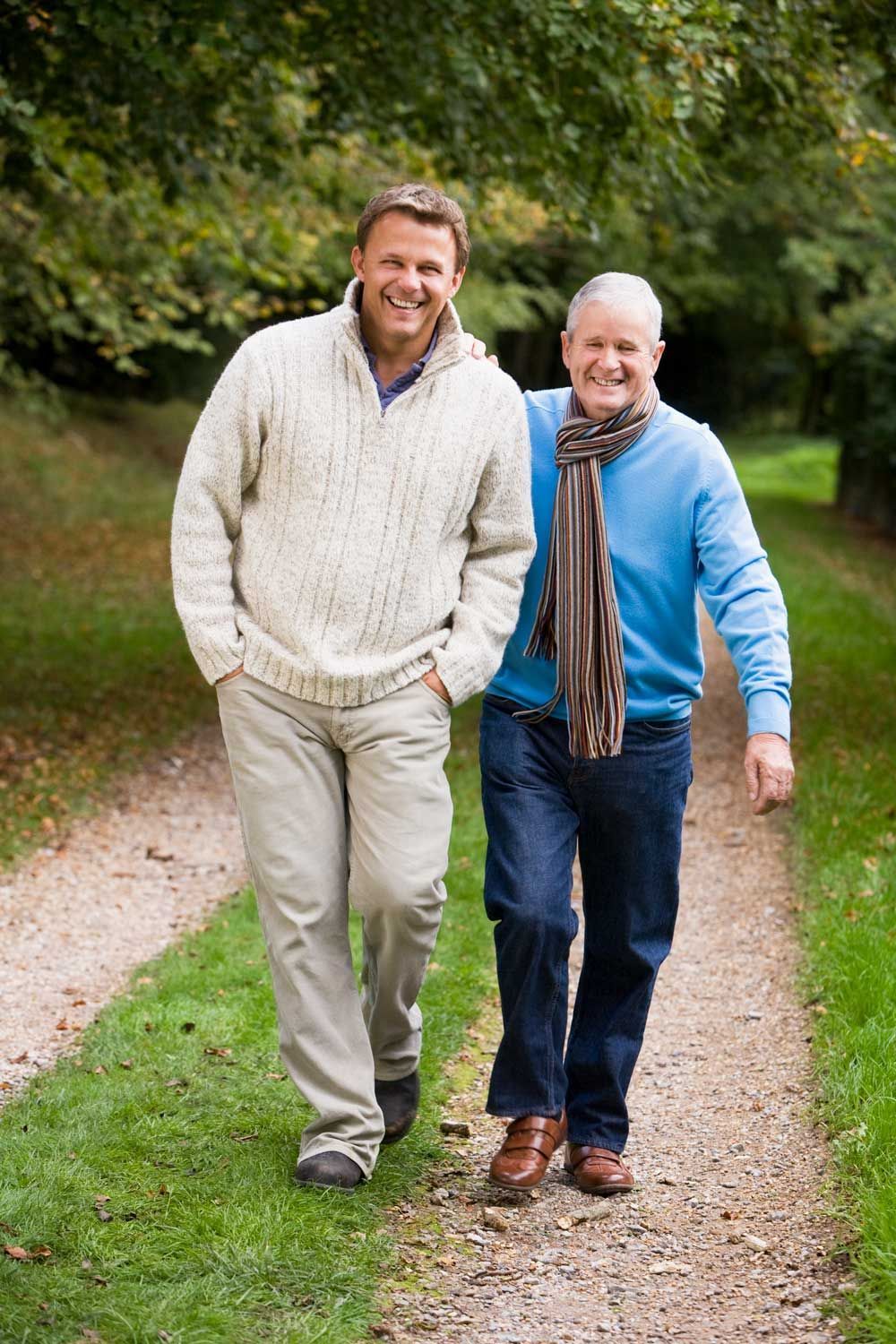Older man and younger man walking on a path