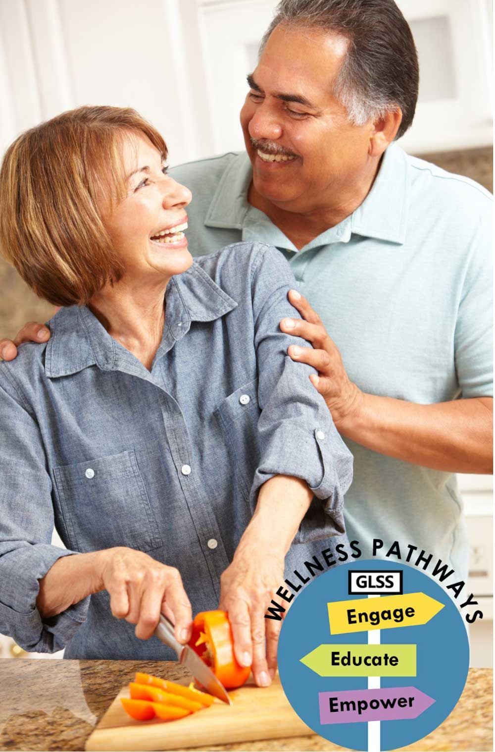 Latino couple cutting healthy food on a cutting board.