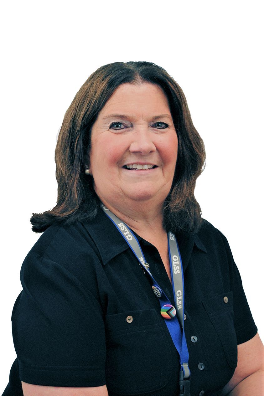 Portrait of a smiling woman in a black shirt and lanyard against a white background