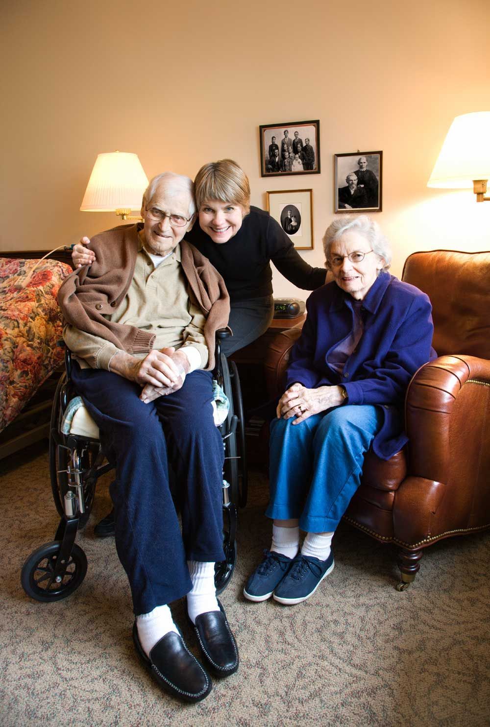 And older couple in a nursing home with someone counseling them.
