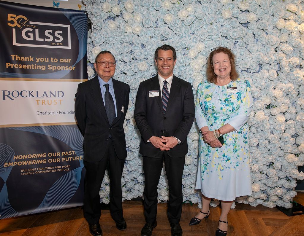 Three people in formal attire a. the GLS 50th anniversary celebration.