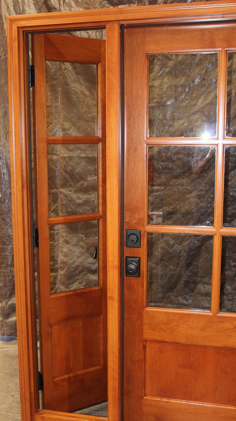A close up of a wooden door with glass panels.