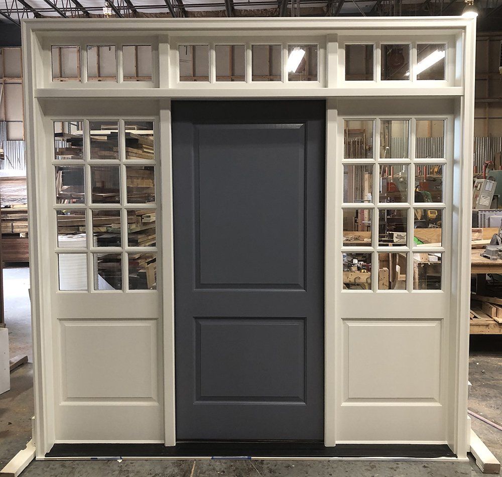 Painted wood door ensemble with extra wide sidelites and transom