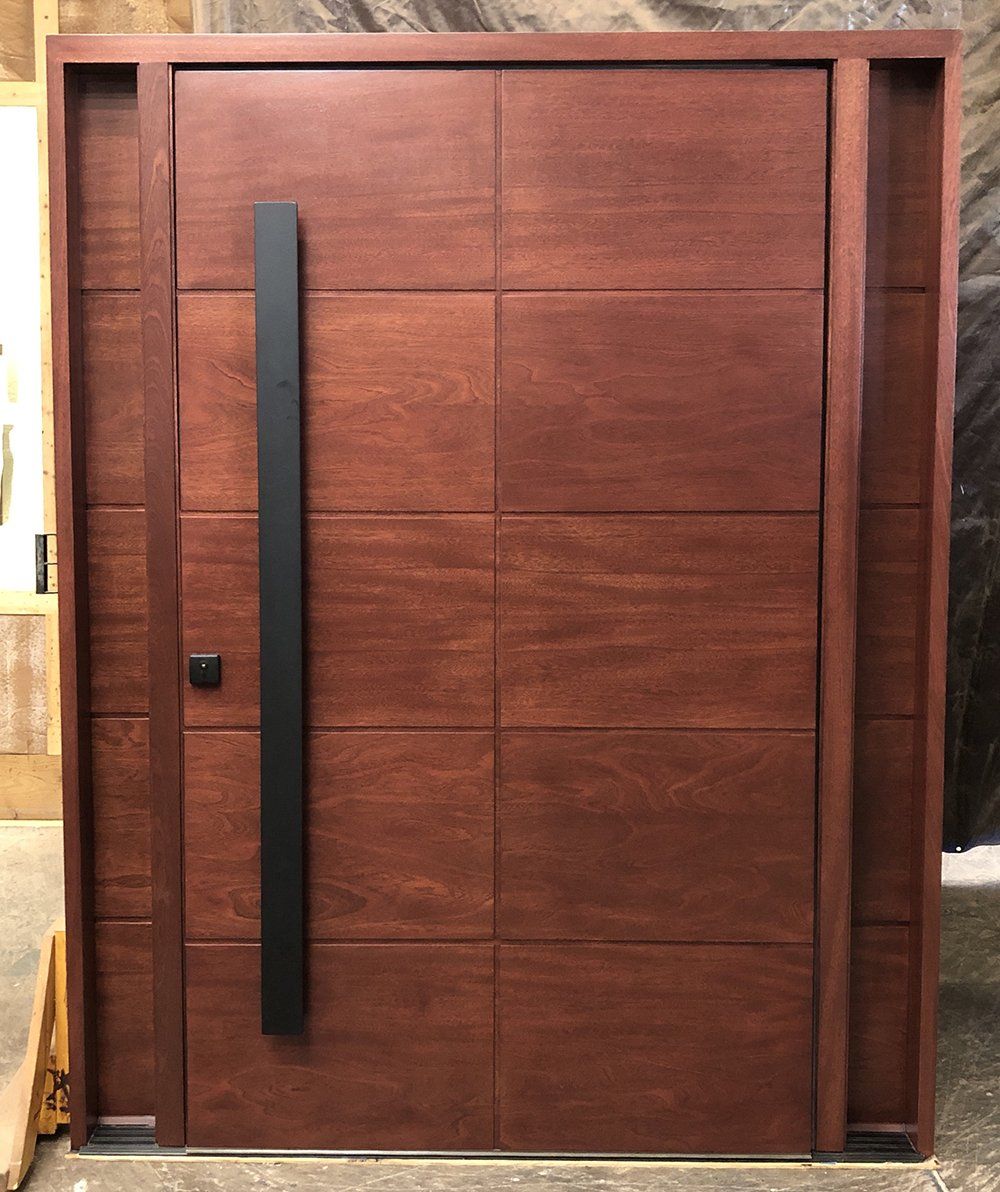 Mahogany flush door with flush sidelite panels and modern minimalist multipoint lockset. Factory finished in Bordeaux color.