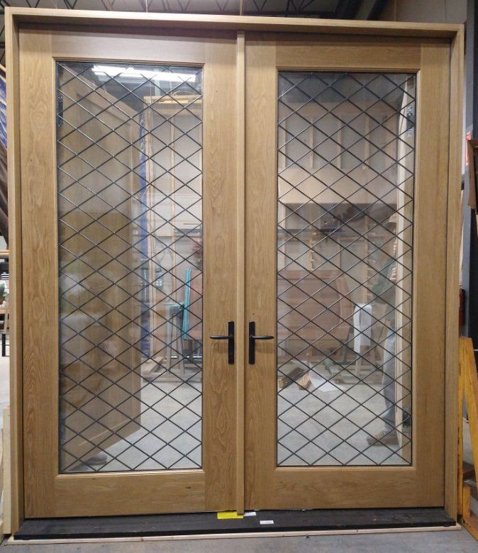 A wooden door with a diamond pattern on the glass