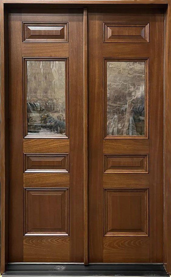 A close up of a wooden door with glass panels.