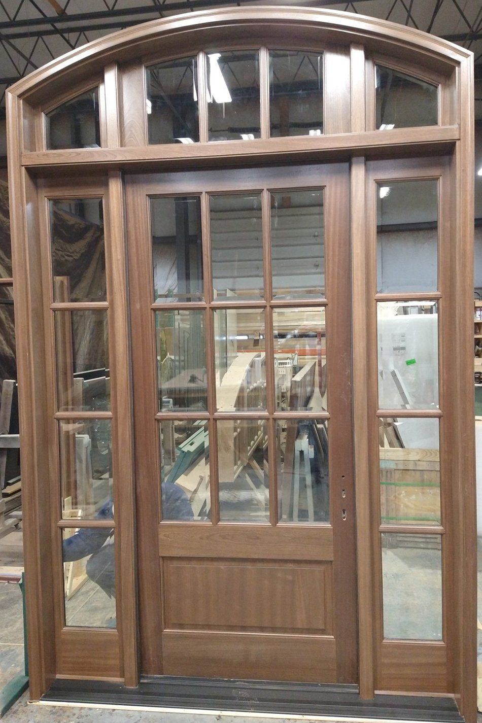 Mahogany entry door with matching sidelites and arched transom
