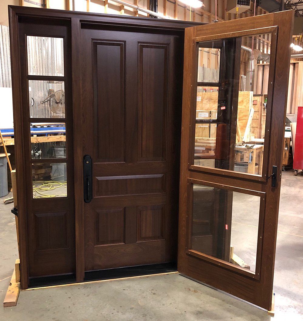A wooden door with a mirror on the side of it