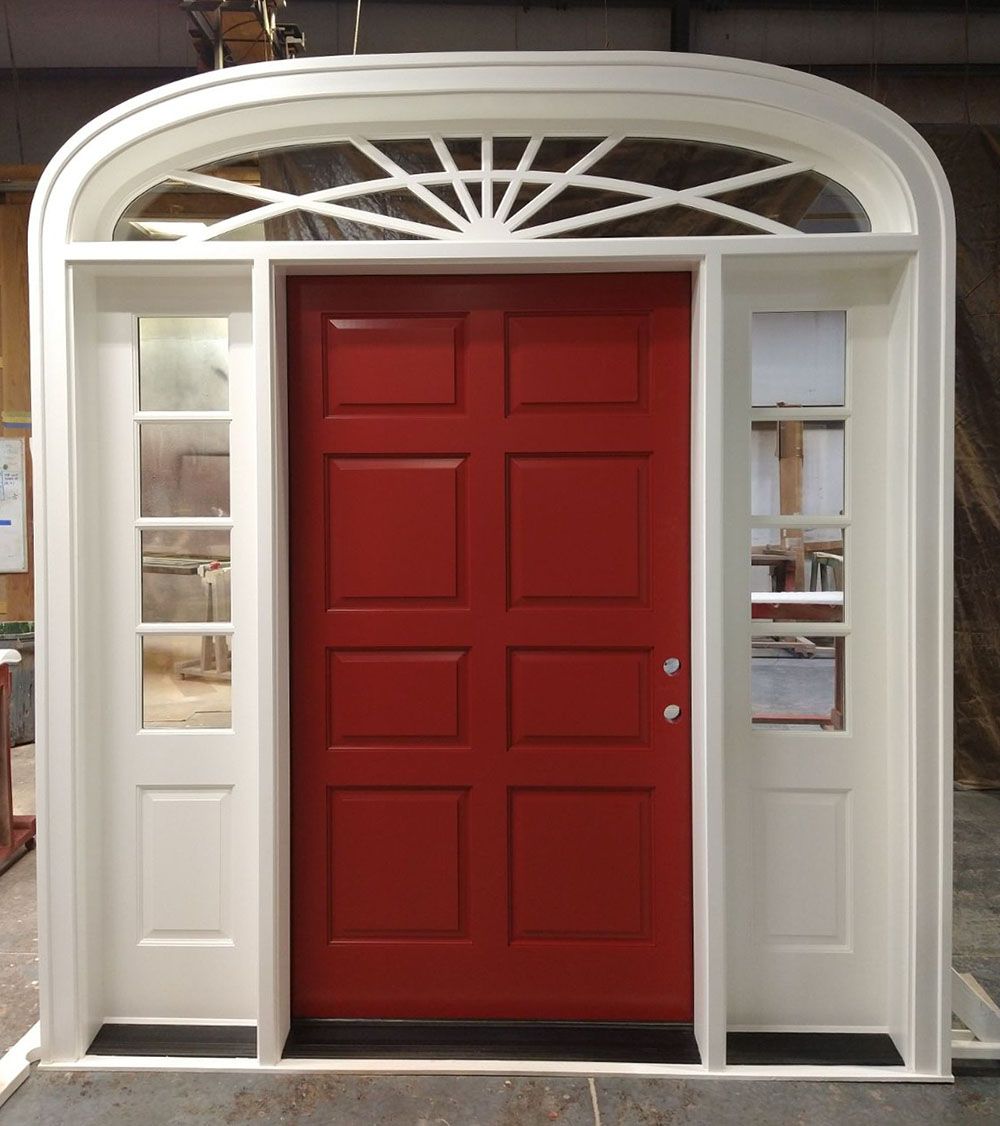 A red door with a white frame and arched window