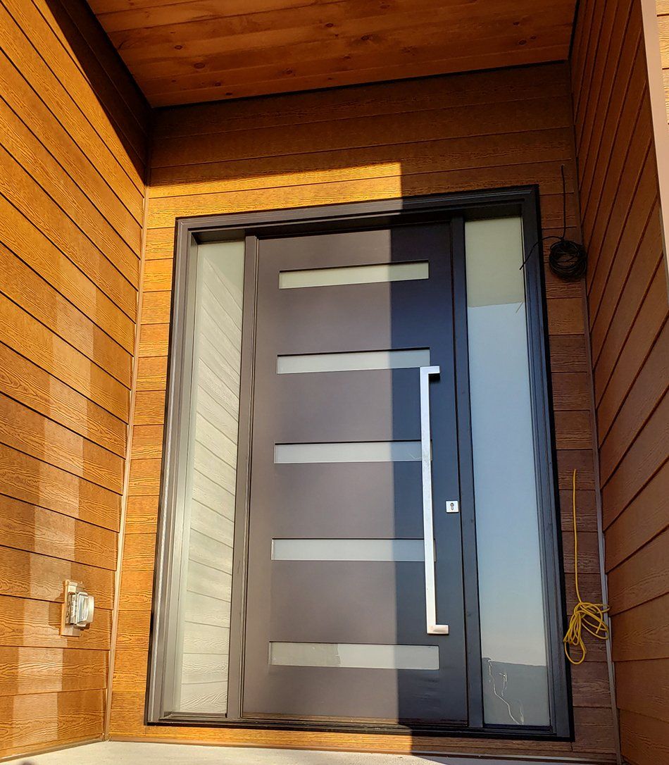 The front door of a house with a wooden wall