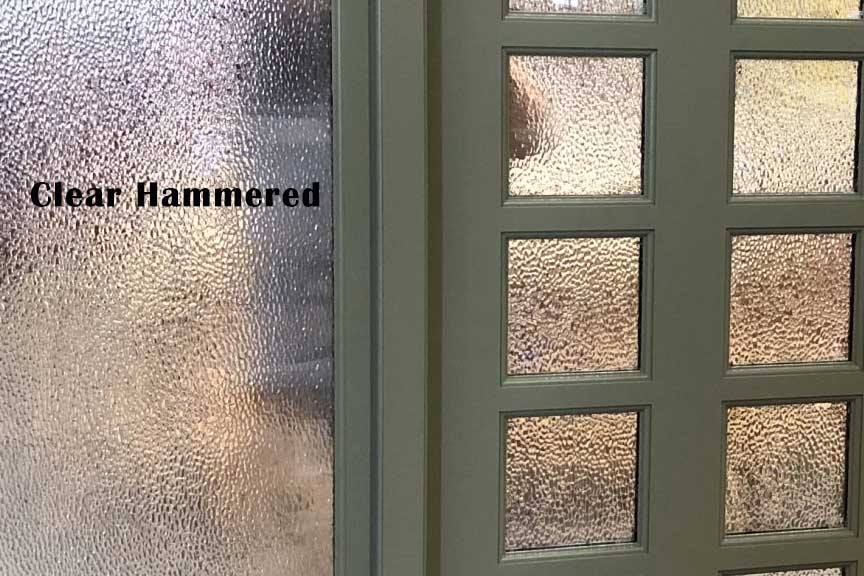 A close up of a clear hammered glass door
