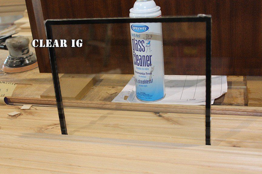 A bottle of clear ig is sitting on a wooden table