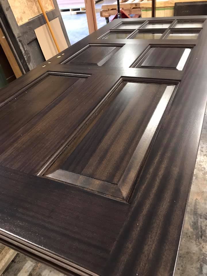 A close up of a wooden door sitting on top of a table.
