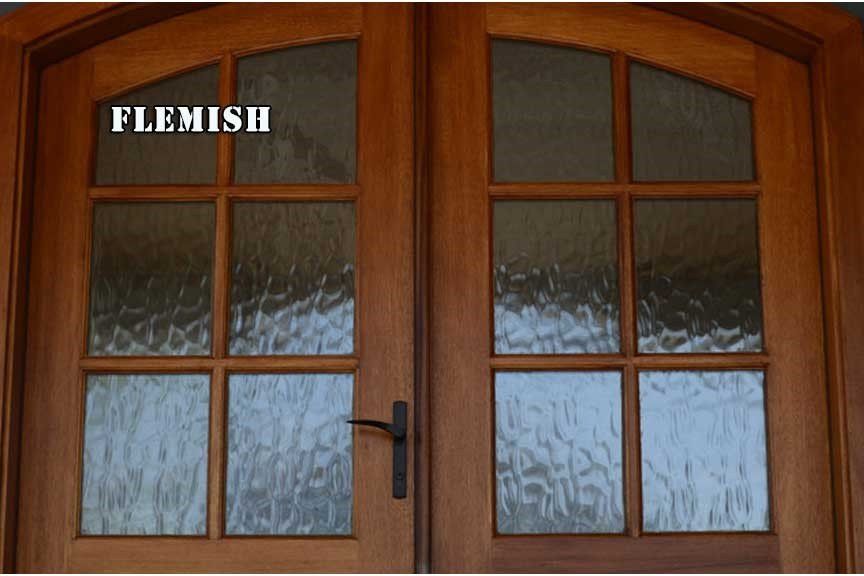 A wooden door with the word flemish above it