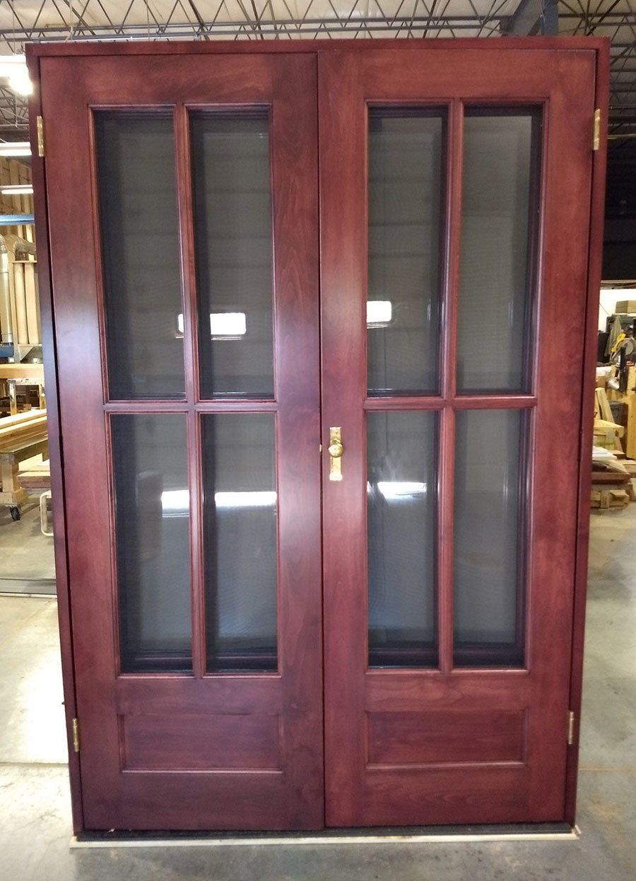 A pair of wooden doors with screens on them