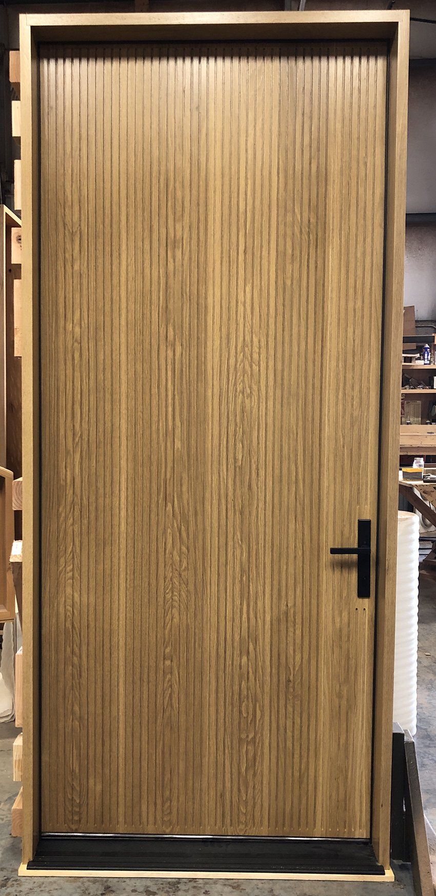 White Oak flush entry door with vertical grooves
