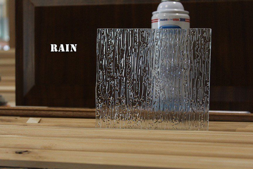 A clear glass block with the word rain on it