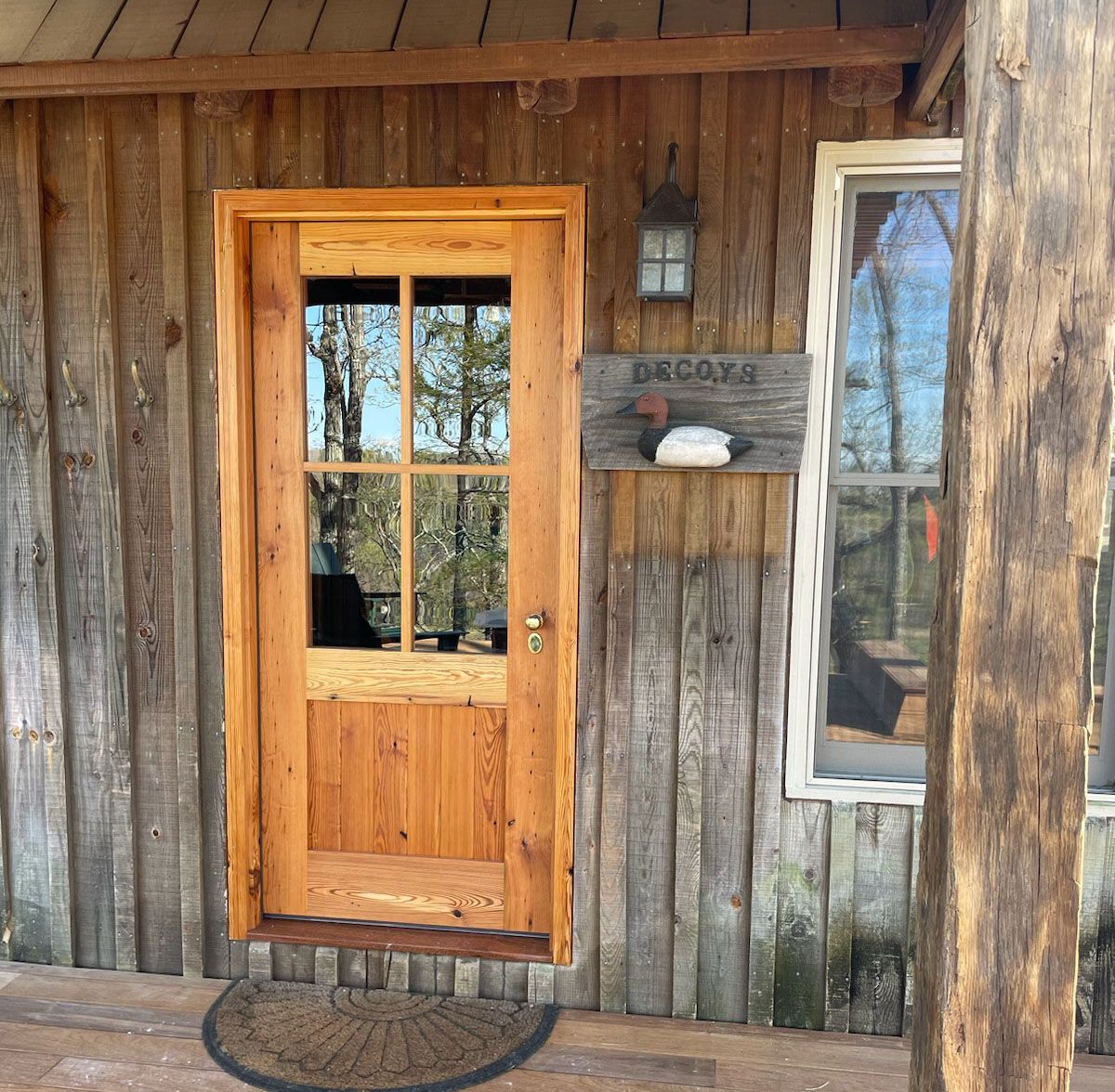 A wooden door with a welcome sign above it