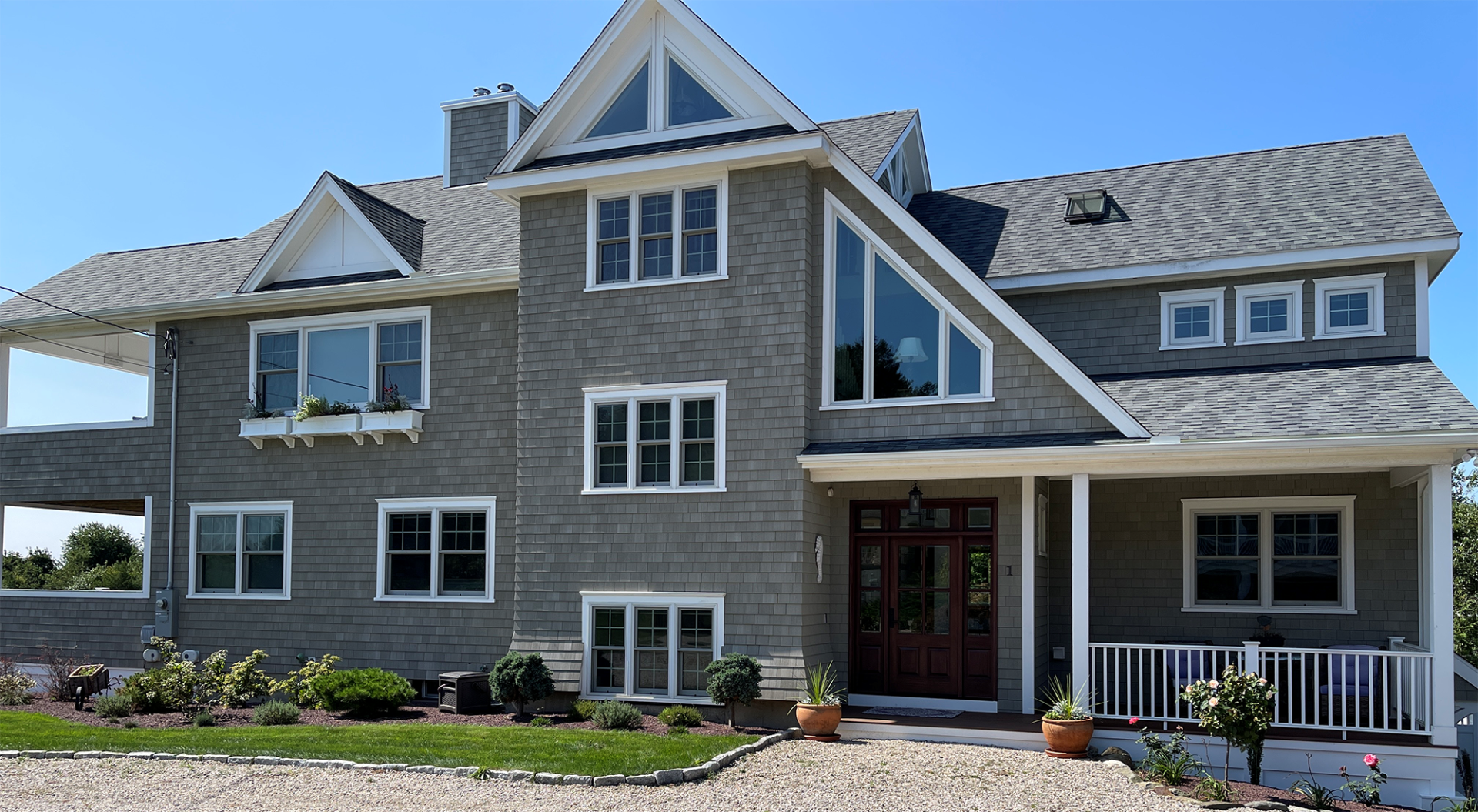 A large house with a lot of windows and a porch