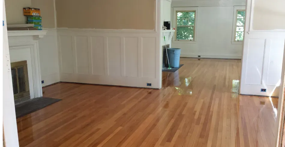 A living room with hardwood floors and a fireplace.