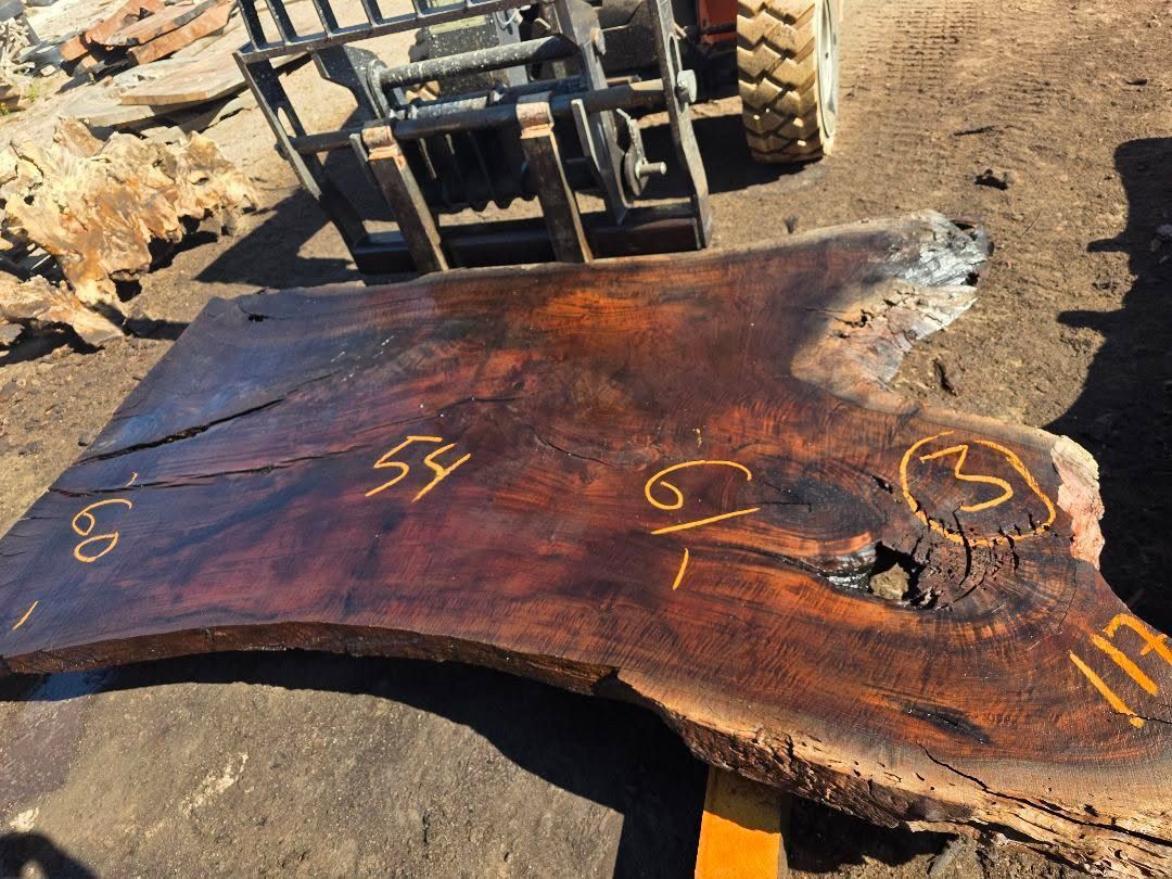 A luxury custom table crafted from rare Bastogne walnut wood showing intricate grain.