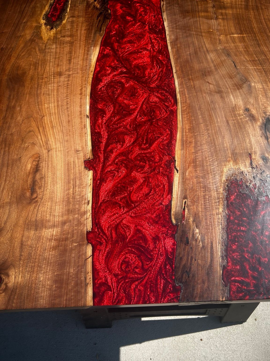 Wooden surface with a vertical red resin inlay and a smaller red accent on the right