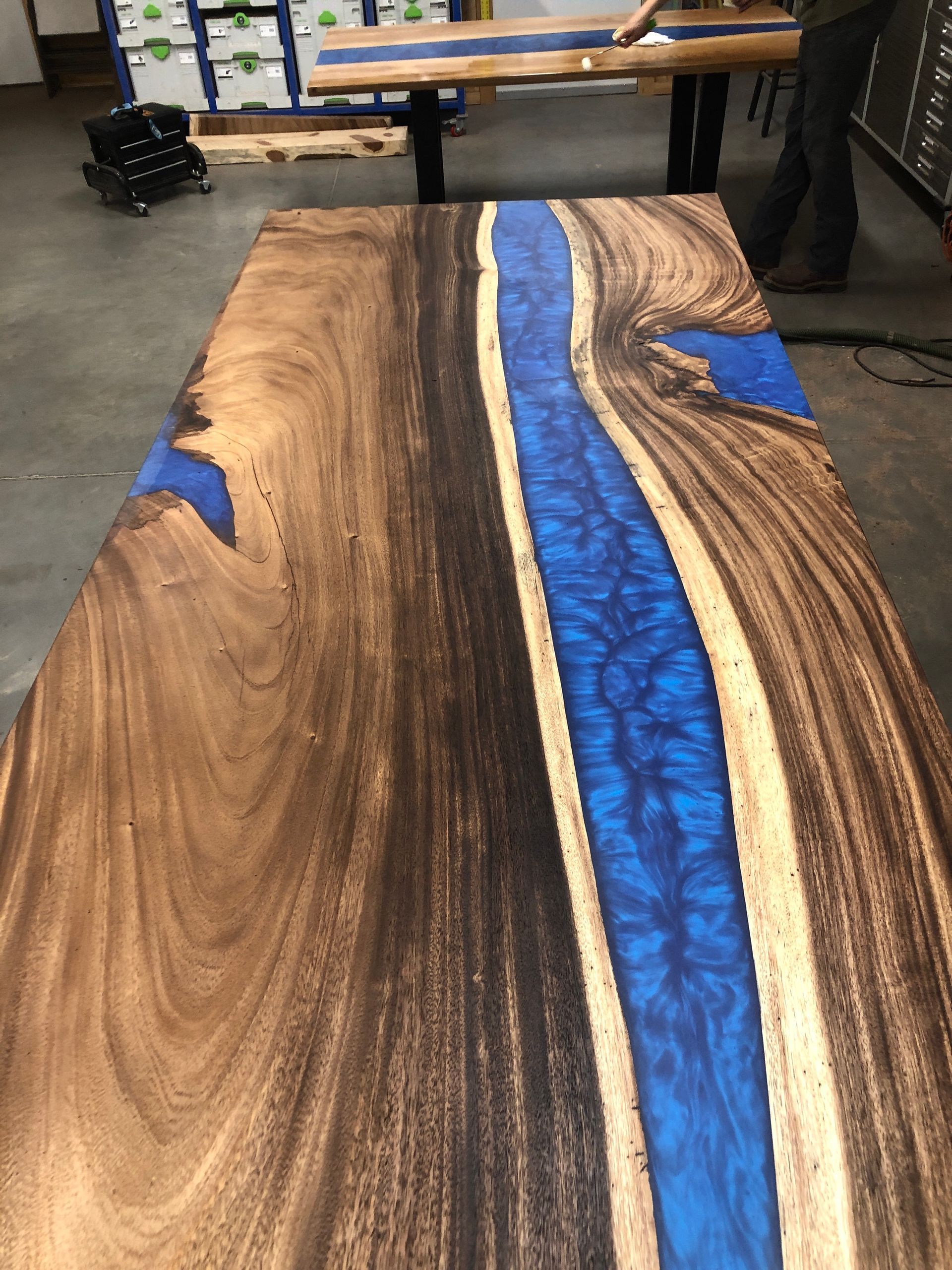 Wood table with blue epoxy river.