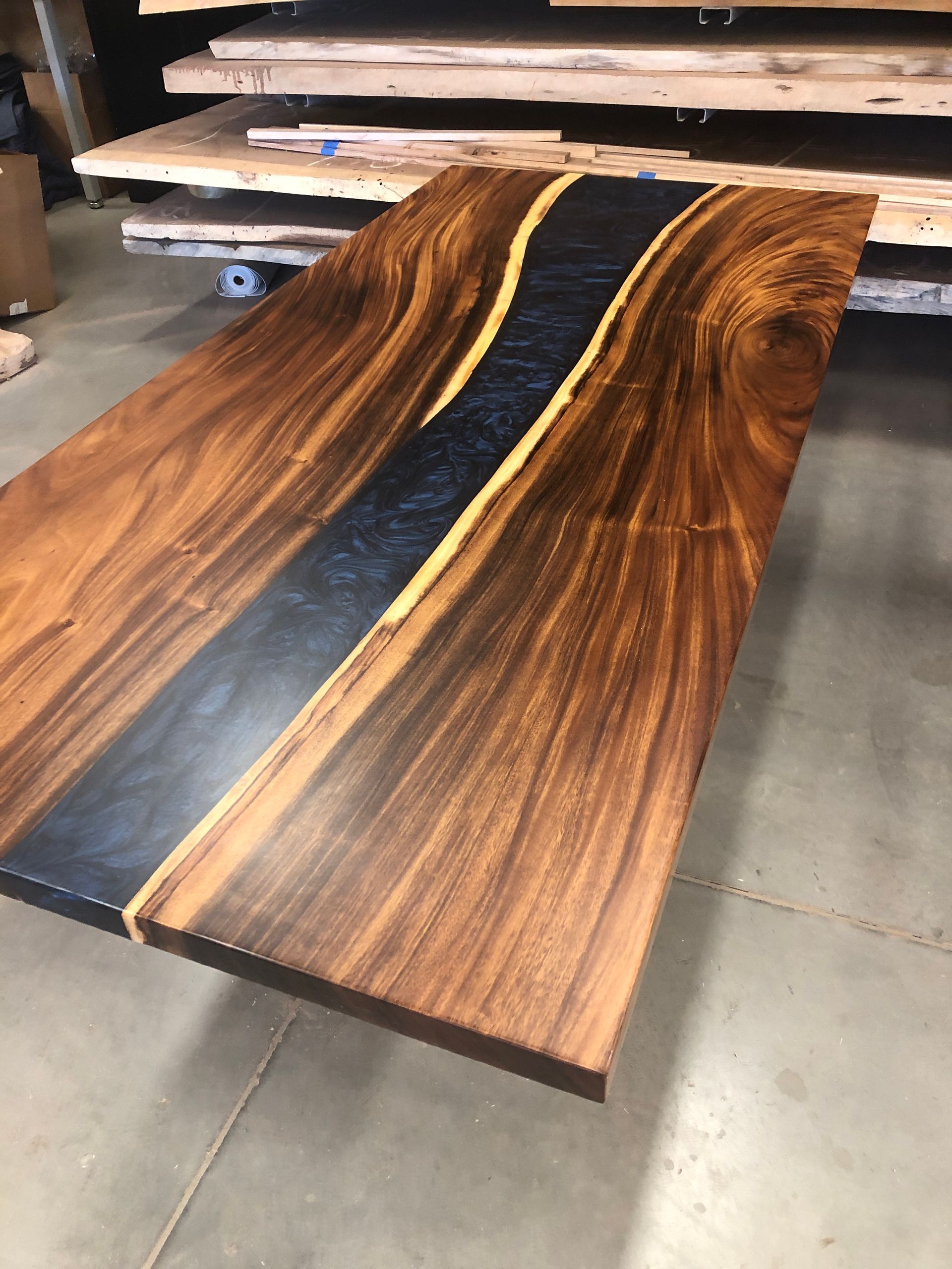 A wooden table is sitting on a concrete floor in a room.