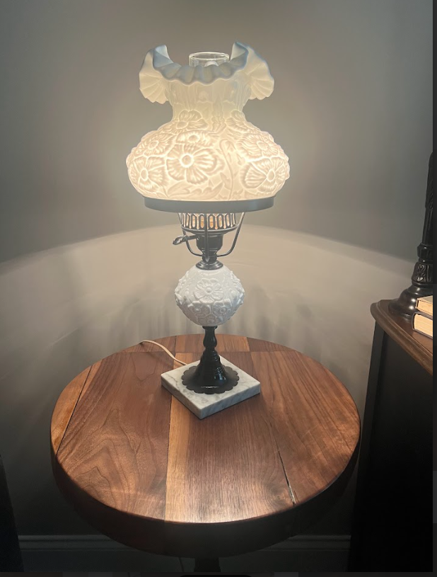 A round wooden table is sitting on a concrete floor.