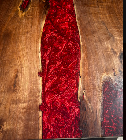 Abstract wood panel with a vivid red resin inlay running vertically through the center.