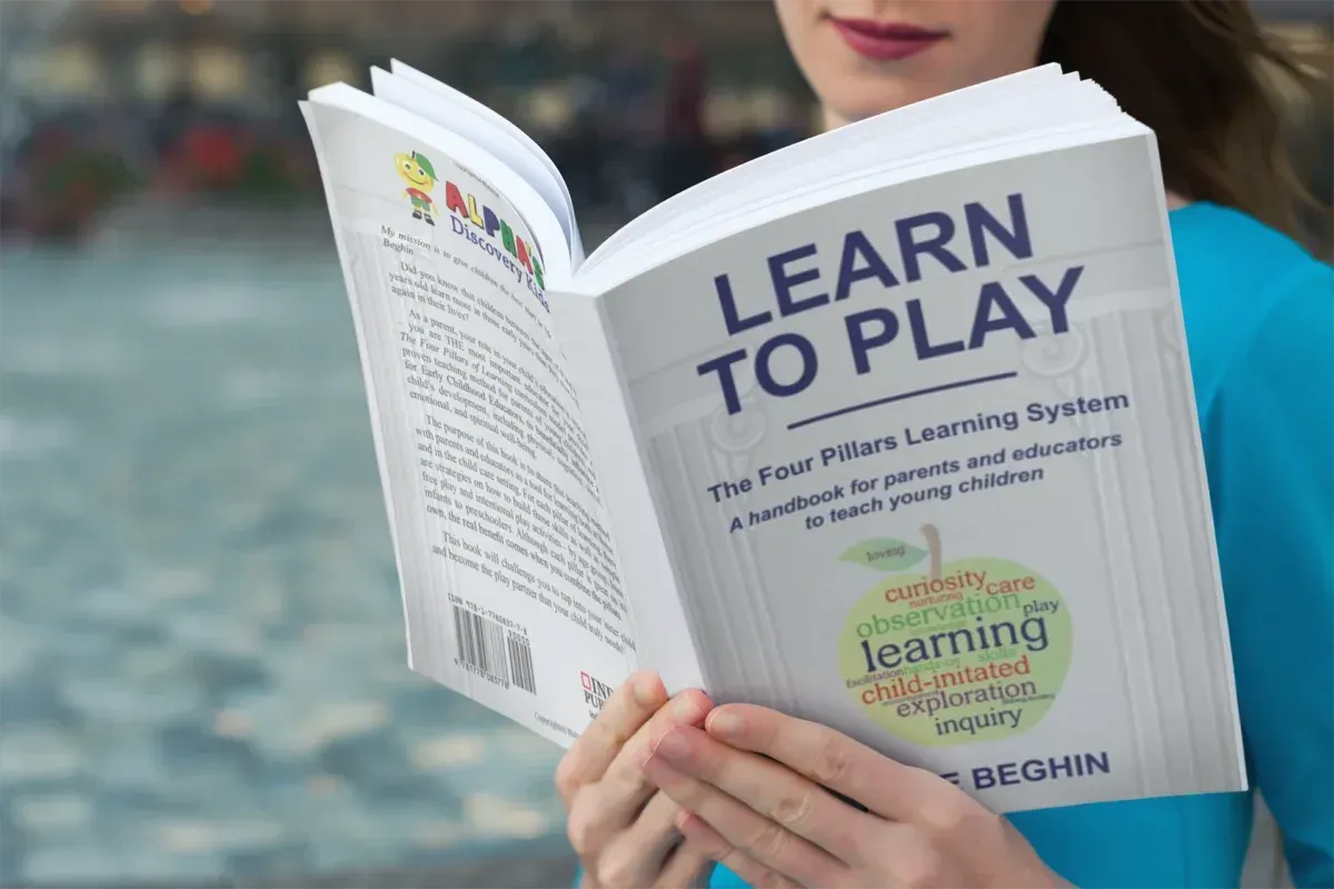 A mother reading Learn to Play: The Four Pillars Learning System.