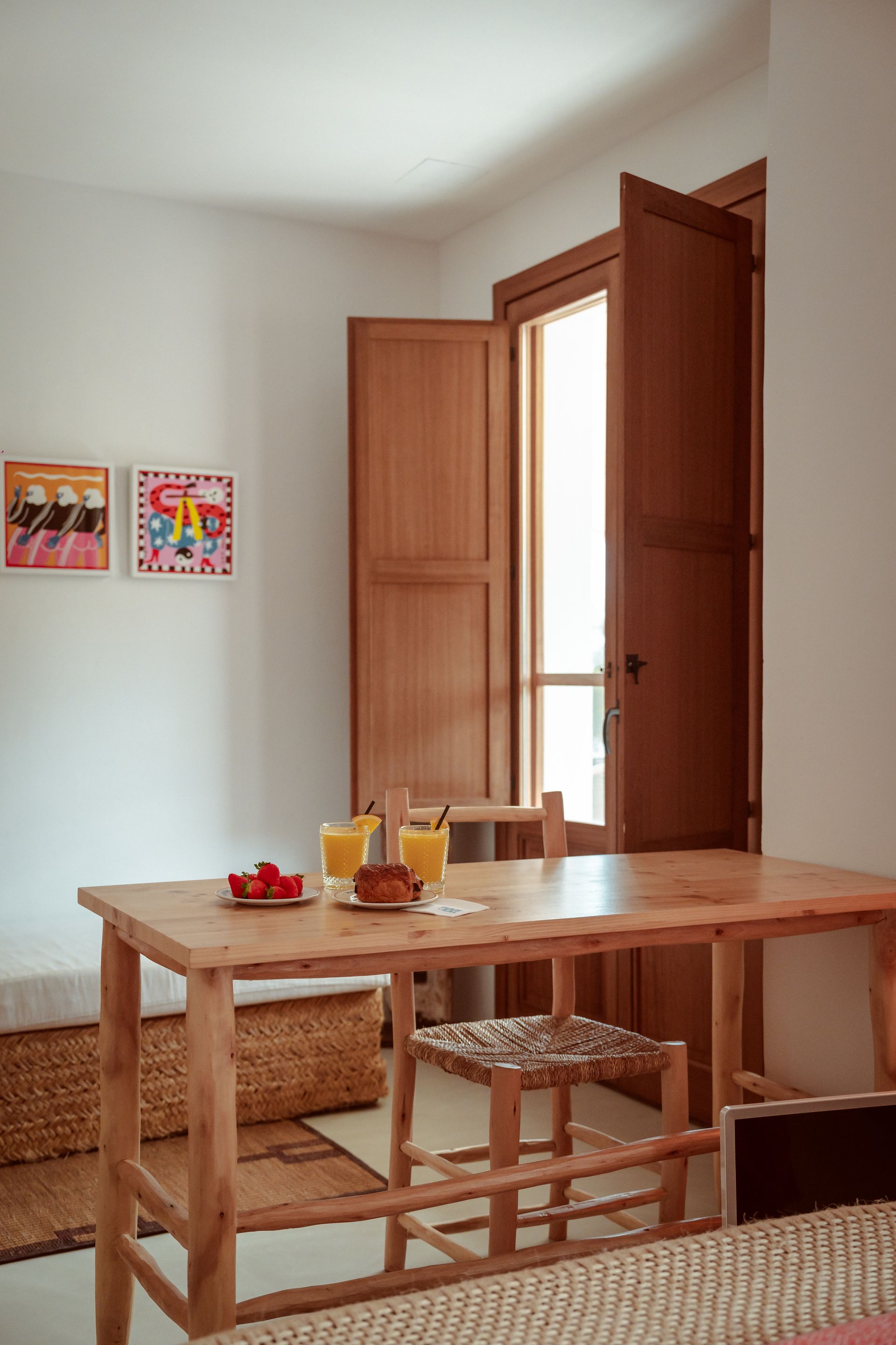 A room with a table and chairs and a window