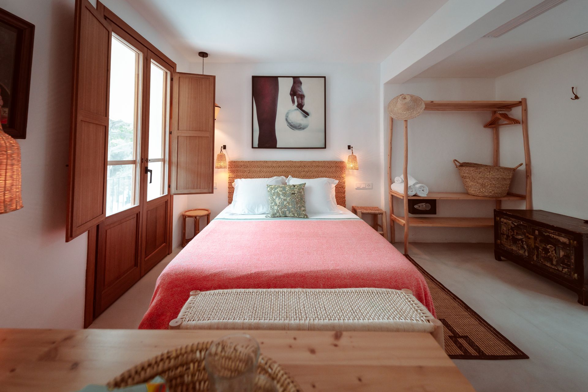 A bedroom with a bed and a painting on the wall