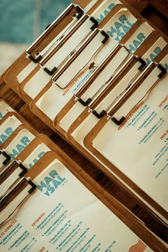 A stack of clipboard menus with the word mar on them