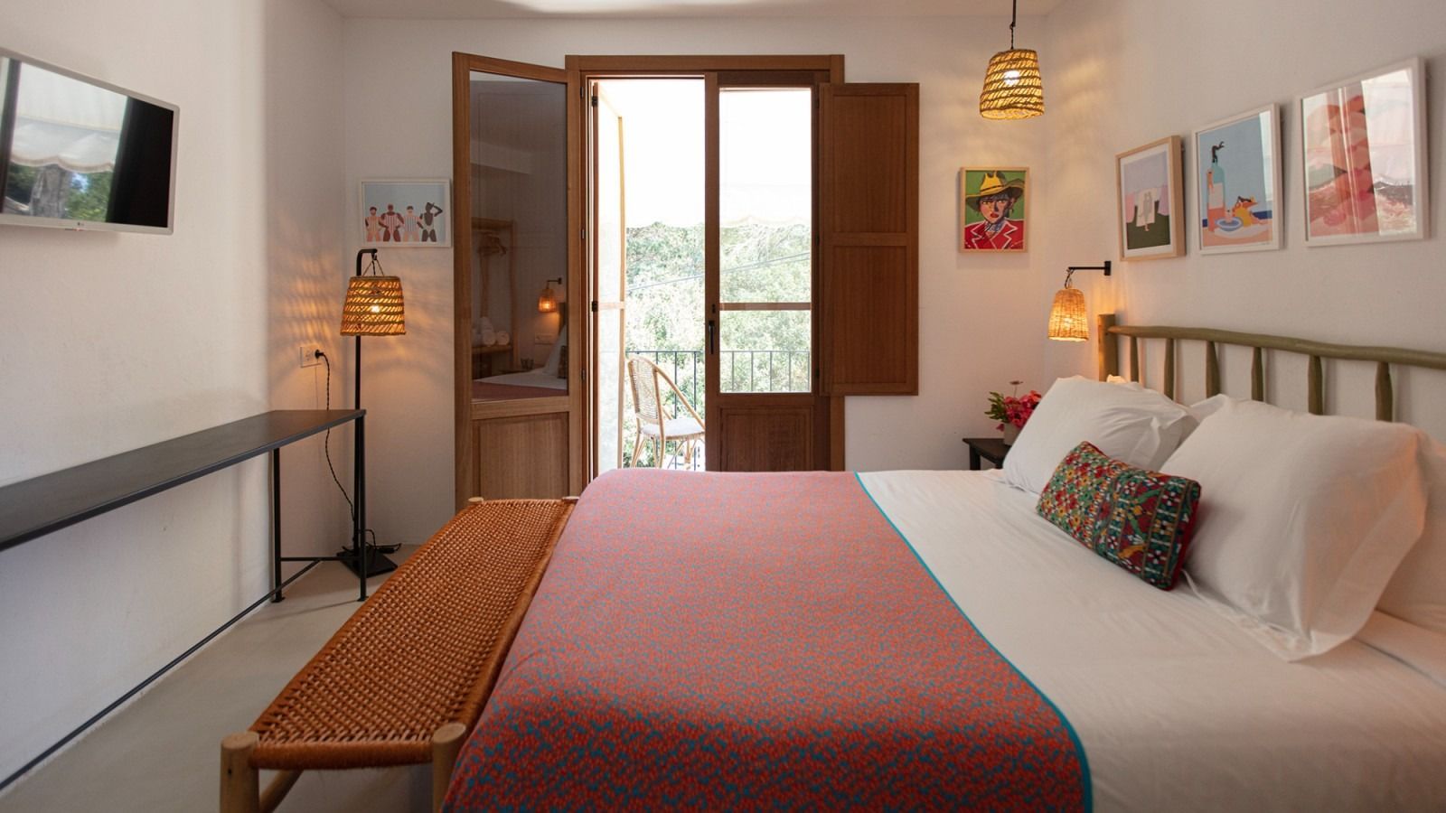 A bedroom with a king size bed and a balcony.